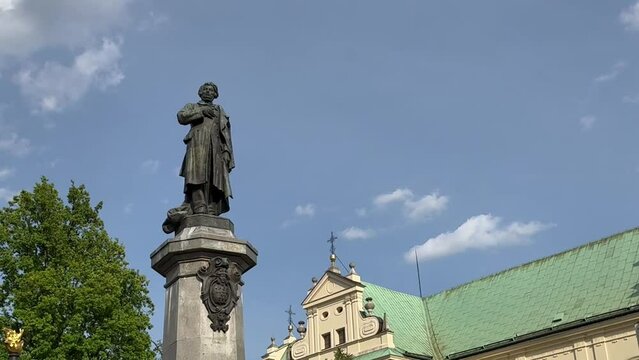 Warsaw, Poland - May 2, 2024, monument to Adam Mickiewicz near the church of the Assumption of the Virgin Mary and of St. Joseph