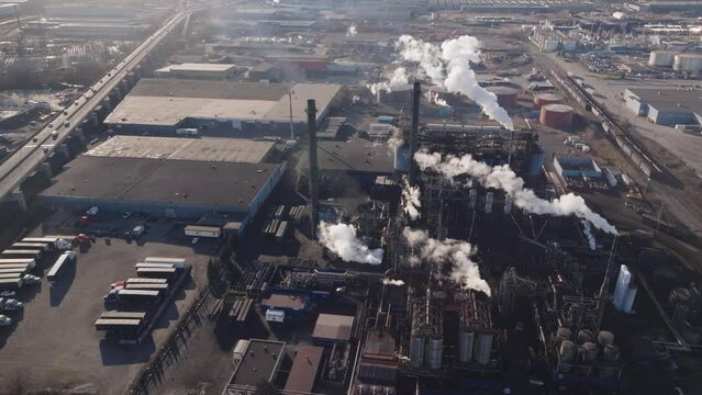 Industrial complex with smokestacks in hamilton, ontario, during daylight, aerial view
