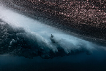 The surfer fall under the wave