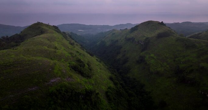 Sunset Over The Green Nature Of Bukit Teletubbies Hill Nusa Penida In Bali, Indonesia. Aerial Drone Shot