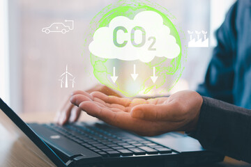 Businessmen pointed out the concept of carbon dioxide icon to reduce carbon dioxide emissions to curb global warming.