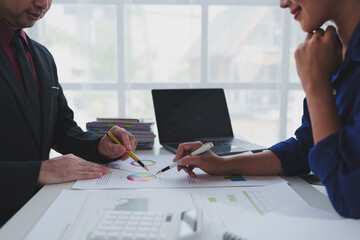 Team of business people working at office. Analyzing, discussing and recording financial budget...