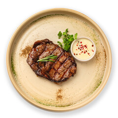 Grilled beef steak on a plate, top view, on a white background.