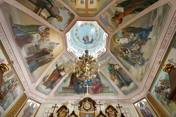 a ceiling with paintings and a clock