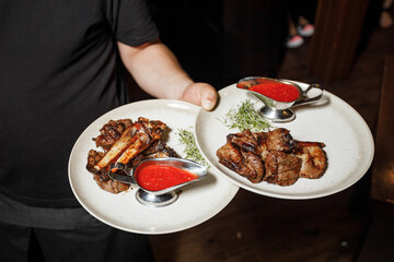 a person holding plates of food