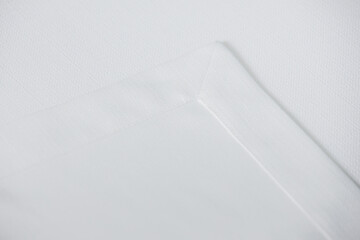 a white fabric with a corner