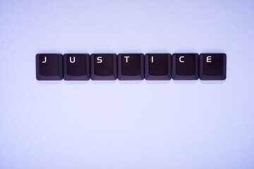 Close-up of the keys of an old keyboard creating justice word