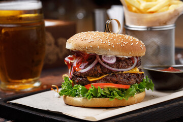 a burger with lettuce and onions on a white napkin