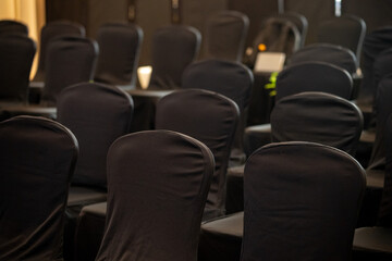 Obraz premium Rows of black banquet chair. Empty row of chair for attendees.
