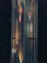 Aerial view of high speed roadways during dawn. Abstract roadway view creative background. Multiple...