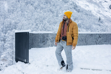 Adventurous Photographer Exploring Snowy Mountain Landscape
