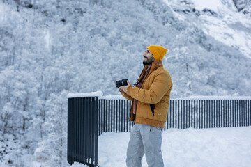 Photographer Capturing Winter Wonderland in Snowy Mountains