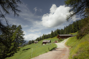 Some old isolated houses over a mountain pasture in Dolomites with wonderful panorama