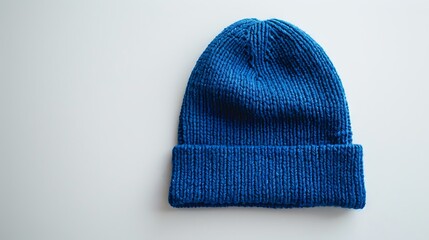 A blue beanie mockup laid flat on a white surface, offering a blank canvas for creative logo placement.
