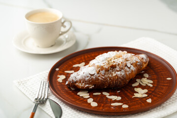 Almond Croissant on clay plate close up