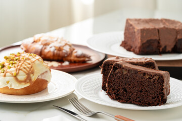 Homemade desserts sponge cake and cinnamon bun on table
