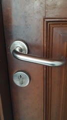 Obraz premium Wooden door with iron cast handle