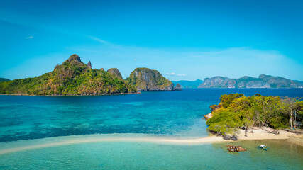 Aerail view of  tropical exotic island sand bar separating sea in two with turquoise  in El Nido, Palawan, Philippines.