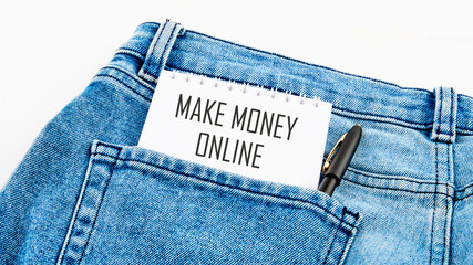 Business concept. MAKE MONEY ONLINE lettering written on a notebook from a pocket next to a pen
