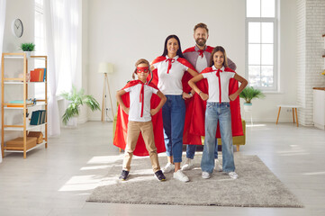 Full length portrait of a cheerful family dressed in colorful superhero costumes at home living room, the parents and children radiate infectious smiles, embodying strength, fun, and unity. - Powered by Adobe