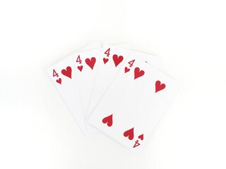 Four identical poker cards with the four of hearts isolated on a white background and space for text