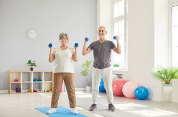 Active happy elderly people, seniors exercising with dumbbells, health care of elderly people, old...