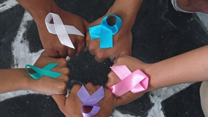 Unity of Diverse Hands with Colorful Cancer Ribbons for World Cancer Day. Community Support People Living and Illness. National Cancer Survival Day. - Powered by Adobe