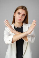 Woman in White Jacket Holding Hands Crossed