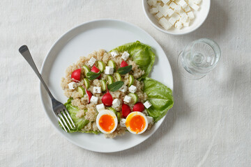 Quinoa salad on white plate from above.