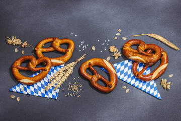 Traditional Oktoberfest Pretzels. German festival food concept. Trendy hard light, dark shadow