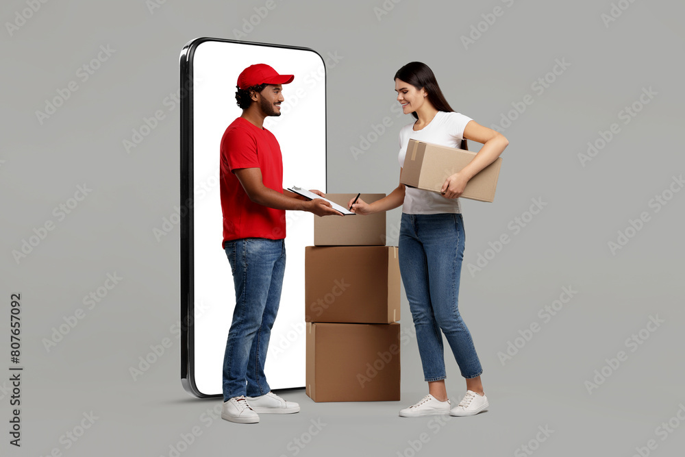 Poster Courier delivering parcels to woman near huge smartphone on grey background