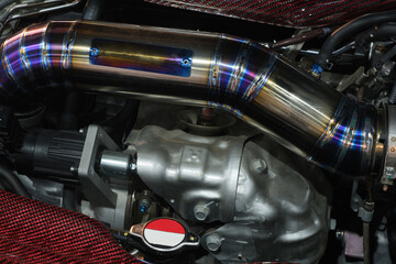 Close-up turbo engine and big iron pipe that installed on car bonnet for modify and tune up power...