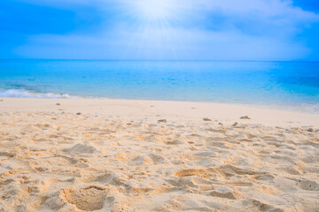 Nature of the beach and sea Summer with sunshine, sandy beaches, clear blue waters sparkling against the blue sky. On an island with good ecology and environment Background for summer vacation	