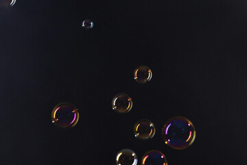 Beautiful transparent soap bubbles on dark background