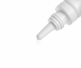 Dripping medical drops from bottle on white background