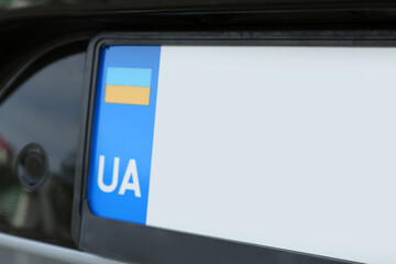 Car with vehicle registration plate, closeup view