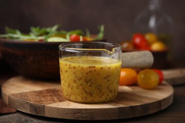 Tasty vinegar based sauce (Vinaigrette) on wooden table, closeup