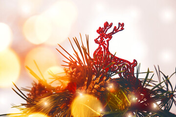 Christmas decorations, pine branches, toys and golden flares lights. Happy New Year and Merry...