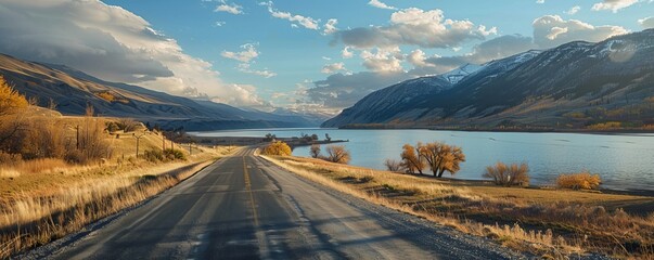 Countryside roadway between mountains and calm lake - Powered by Adobe