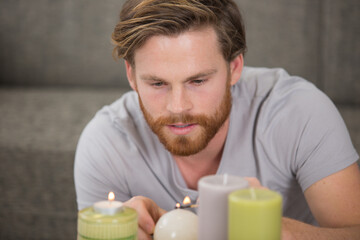 man lighting candles in the home