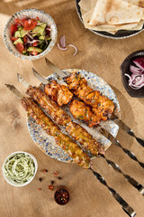 Outdoor Summer Barbecue Featuring Shashlik Skewers with Lavash and Onions on a Rustic Table
