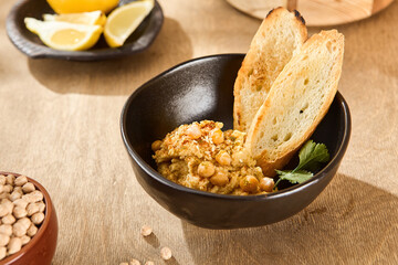 Refreshing Midday Snack: Hummus and Toasted Bread in Sunlit Modern Kitchen