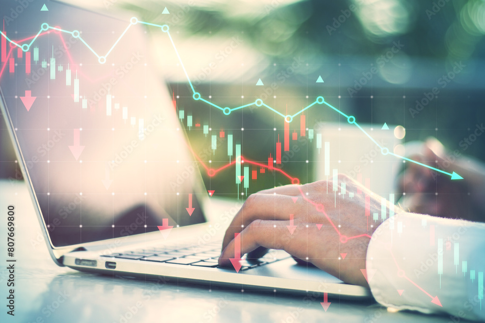 Poster side view of male hands using laptop at desk with coffee cup and falling red forex chart and map on 
