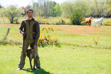 hunter with shotgun in the autumn forest