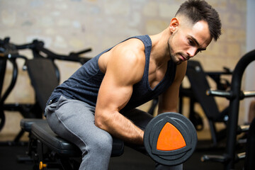 young athlete training biceps muscles