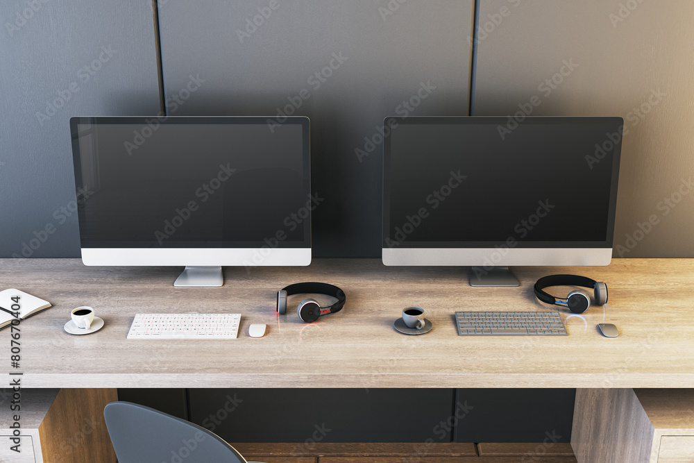 Poster Two empty gaming computer screens on desk with coffee cups and headsets. Place for your advertisement. Gaming club concept. Mock up, 3D Rendering.