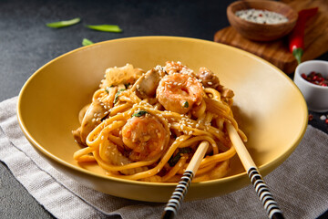 Asian-style shrimp noodles in a yellow bowl; an enticing and savory dish perfectly styled for...