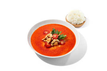 Traditional thai soup tom yam with chicken meat on white background. Tom kha in minimal style with chicken and mushrooms. Asian soup with spicy and chicken isolation on white background