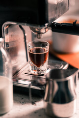 Close up preparing espresso coffee in automatic home small coffee machine at the kitchen