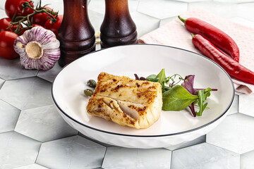 Roasted cod fish steak with salad